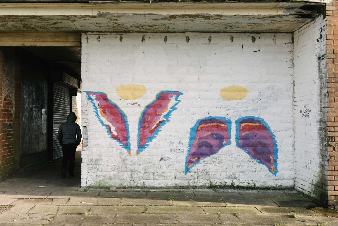 A mural on a wall white butterfly wings