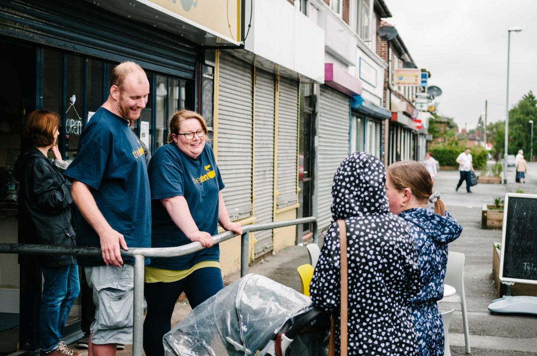 People standing in the street talking